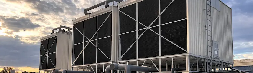 industrial rooftop cooling towers at dusk.webp